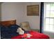 Bright bedroom with a comfortable chair, window with blind, and cozy decor at 503 N Franklin Dr, Sanford, NC 27330