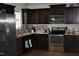 Modern kitchen featuring stainless steel appliances, dark wood cabinets, and stylish backsplash at 503 N Franklin Dr, Sanford, NC 27330