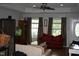 Inviting living room with ample natural light, complemented by neutral walls and a ceiling fan at 503 N Franklin Dr, Sanford, NC 27330