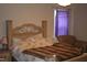 Comfortable bedroom with a decorative wood headboard and a cozy seating area at 503 N Franklin Dr, Sanford, NC 27330