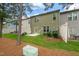 Backyard featuring green grass, a small patio, and mature trees at 507 Brier Crossings Loop, Durham, NC 27703