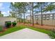 Fenced backyard featuring green grass, tall trees and a patio area at 507 Brier Crossings Loop, Durham, NC 27703