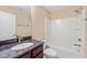 Bathroom with granite-topped vanity and a shower-tub combination with white surround at 507 Brier Crossings Loop, Durham, NC 27703