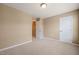 Neutral carpeted bedroom with two doors and a window in the background at 507 Brier Crossings Loop, Durham, NC 27703