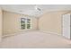 Neutral bedroom with ceiling fan, carpet flooring, and ample natural light at 507 Brier Crossings Loop, Durham, NC 27703