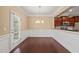 Elegant dining area with a stylish chandelier, white wainscoting, and easy access to the kitchen at 507 Brier Crossings Loop, Durham, NC 27703