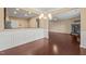 Dining room with hardwood floors, wainscoting, and views into the open living room and kitchen at 507 Brier Crossings Loop, Durham, NC 27703
