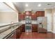 Well-lit kitchen with stainless steel appliances, granite countertops, and wood floors at 507 Brier Crossings Loop, Durham, NC 27703
