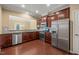 Modern kitchen with stainless steel appliances, granite countertops, and dark wood cabinets at 507 Brier Crossings Loop, Durham, NC 27703