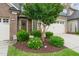 Well-maintained landscaping with green shrubs and mulch bed around the front of the house at 507 Brier Crossings Loop, Durham, NC 27703