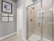 Modern bathroom showcasing a glass-enclosed shower with neutral tile and an adjacent linen closet at 509 Kildaire Farm Rd # 106, Cary, NC 27511