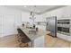 Bright modern kitchen featuring stainless steel appliances, granite countertops, and stylish island seating at 509 Kildaire Farm Rd # 106, Cary, NC 27511
