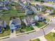 Aerial view of a neighborhood with well-manicured lawns, fences, and a firepit at 525 Willow Breeze Ct, Zebulon, NC 27597