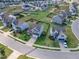 Aerial view showcases a community with green lawns and neatly aligned homes at 525 Willow Breeze Ct, Zebulon, NC 27597