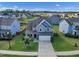 Aerial view of a two-story home in a neighborhood with well-manicured lawns at 525 Willow Breeze Ct, Zebulon, NC 27597