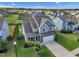 Aerial view of a two-story home with a well-kept lawn in a suburban neighborhood at 525 Willow Breeze Ct, Zebulon, NC 27597