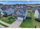 Aerial view of a two-story home in a neighborhood with well-manicured lawns at 525 Willow Breeze Ct, Zebulon, NC 27597