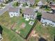 Aerial view of the home's fenced backyard with a fire pit and patio at 525 Willow Breeze Ct, Zebulon, NC 27597