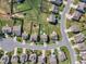 An aerial view of a residential neighborhood showcasing well-maintained lawns and tree-lined streets on a sunny day at 525 Willow Breeze Ct, Zebulon, NC 27597