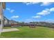 Expansive backyard with green grass, wood fence, and lounge and firepit seating areas at 525 Willow Breeze Ct, Zebulon, NC 27597
