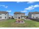 Enjoy the backyard with fire pit, lounge area, and spacious green lawn at 525 Willow Breeze Ct, Zebulon, NC 27597