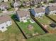 Aerial view of a fenced backyard featuring green lawn, a patio, a fire pit, and recreational area at 525 Willow Breeze Ct, Zebulon, NC 27597