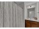 Bathroom with patterned shower curtain, vanity, and sink at 525 Willow Breeze Ct, Zebulon, NC 27597