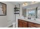 Modern bathroom with double sinks, storage shelves, and view of the outside at 525 Willow Breeze Ct, Zebulon, NC 27597