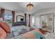Bright bedroom featuring a patterned quilt, chandelier, and bathroom access at 525 Willow Breeze Ct, Zebulon, NC 27597