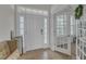 Spacious entryway with natural light, featuring a bench for seating and easy access to a home office at 525 Willow Breeze Ct, Zebulon, NC 27597