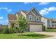 Well-maintained home with a lush green lawn, mature tree, and attached two-car garage, adding to its appeal at 525 Willow Breeze Ct, Zebulon, NC 27597