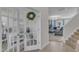 Inviting hallway view featuring a home office behind French doors and a staircase leading to the upper level at 525 Willow Breeze Ct, Zebulon, NC 27597