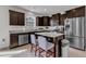 Kitchen features stainless steel appliances, granite countertops, an island with barstool seating, and ample cabinet space at 525 Willow Breeze Ct, Zebulon, NC 27597