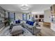 Bright and airy living room featuring comfortable seating, a modern aesthetic, and an open layout to the kitchen at 525 Willow Breeze Ct, Zebulon, NC 27597