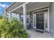 Welcoming front porch featuring stone accents, comfortable seating, and a charming 
