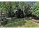 Large, grassy backyard with mature trees, offering a private and peaceful outdoor space at 5309 Overtop Ln, Raleigh, NC 27613