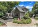 Two-story home with a well-maintained backyard, stone patio, and lush landscaping for outdoor enjoyment at 5309 Overtop Ln, Raleigh, NC 27613