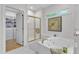 Bathroom featuring a glass enclosed shower, soaking tub, and walk-in closet at 5309 Overtop Ln, Raleigh, NC 27613