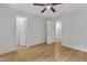 Bright bedroom features hardwood floors, ceiling fan, and an open walk-in closet at 5309 Overtop Ln, Raleigh, NC 27613