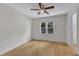 Bedroom with ceiling fan and a single window view to the trees outside at 5309 Overtop Ln, Raleigh, NC 27613