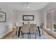 Elegant dining room featuring modern decor, a glass table, and stylish chairs at 5309 Overtop Ln, Raleigh, NC 27613