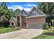 Beautiful brick home with a manicured lawn and mature trees offering great curb appeal at 5309 Overtop Ln, Raleigh, NC 27613