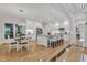 Modern kitchen and dining area featuring stainless steel appliances, quartz countertops, and hardwood flooring at 5309 Overtop Ln, Raleigh, NC 27613