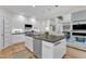 Modern kitchen featuring white cabinets, an island with bar seating, and stainless steel appliances at 5309 Overtop Ln, Raleigh, NC 27613