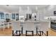 Bright modern kitchen featuring a large island, stainless appliances and hardwood floors at 5309 Overtop Ln, Raleigh, NC 27613