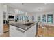 Kitchen island with a sink offers seating in this open concept floor plan at 5309 Overtop Ln, Raleigh, NC 27613