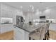 Contemporary kitchen with large island, stainless steel appliances, and modern lighting at 5309 Overtop Ln, Raleigh, NC 27613