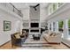Open living room area showcases a floor-to-ceiling fireplace, and access to a second-story loft at 5309 Overtop Ln, Raleigh, NC 27613