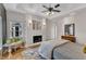 Comfortable main bedroom with a fireplace, hardwood floors, and a seating area by the window at 5309 Overtop Ln, Raleigh, NC 27613