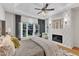 Bright main bedroom features a modern fireplace, stylish decor, and a cozy seating area at 5309 Overtop Ln, Raleigh, NC 27613